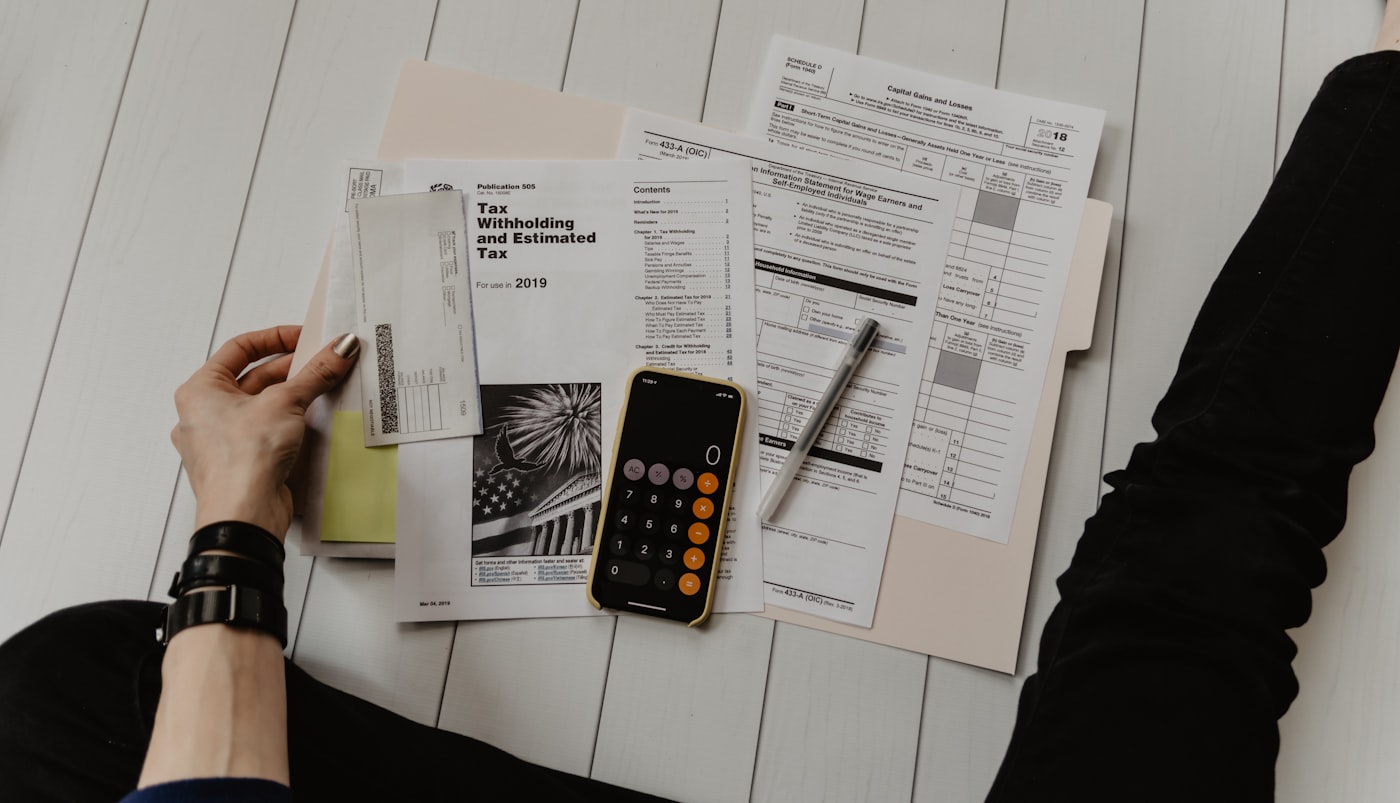 Financial documents, charts and a calculator on a desk